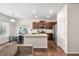 Bright and spacious kitchen with stainless steel appliances, a kitchen island, and dining area at 1518 Sepia Ave, Longmont, CO 80501