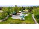 Lush park with a splash pad, playground, picnic tables, and mature trees, creating a vibrant and community-focused recreation area at 1518 Sepia Ave, Longmont, CO 80501