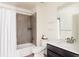 Clean bathroom featuring a shower-tub combination with a white shower curtain and a dark vanity at 14537 Honolulu Cir, Parker, CO 80134