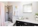 Modern bathroom with sleek vanity, shower with gray tile, and stylish fixtures at 14537 Honolulu Cir, Parker, CO 80134