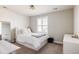 Sun-filled bedroom with large window, neutral decor, white furniture, and carpet at 14537 Honolulu Cir, Parker, CO 80134