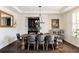 Elegant dining room features a large wooden table with tufted chairs and sophisticated decor at 14537 Honolulu Cir, Parker, CO 80134