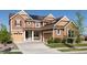Charming two-story home featuring a two-car garage, well-maintained lawn, and solar panels for energy efficiency at 14537 Honolulu Cir, Parker, CO 80134