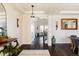 Stunning home foyer features dark hardwood floors, elegant light fixtures, and staircase access at 14537 Honolulu Cir, Parker, CO 80134