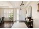 Bright foyer with hardwood floors, tall ceilings, plantation shutters, and an elegant console table with decor at 14537 Honolulu Cir, Parker, CO 80134