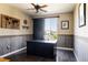 Well-lit home office with a large desk, sliding barn door, and wood-look floors at 14537 Honolulu Cir, Parker, CO 80134