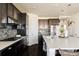 Spacious kitchen features a large island with seating, modern appliances, and ample cabinet space at 14537 Honolulu Cir, Parker, CO 80134
