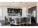 Modern kitchen with an oversized island, quartz countertops, stainless steel appliances, and stylish bar seating at 14537 Honolulu Cir, Parker, CO 80134