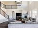 Spacious living room with a fireplace, two-story ceilings, and large windows, perfect for gathering at 14537 Honolulu Cir, Parker, CO 80134