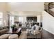Open-concept living room flows into the kitchen, featuring hardwood floors and lots of natural light at 14537 Honolulu Cir, Parker, CO 80134