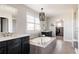 Luxurious bathroom featuring a soaking tub, double vanity, and walk-in closet access at 14537 Honolulu Cir, Parker, CO 80134