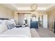 Spacious primary bedroom with barn door, dresser, and sitting bench at 14537 Honolulu Cir, Parker, CO 80134