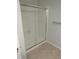 Bathroom with a tub and shower with a glass door at 559 Alton Way # E, Denver, CO 80230