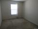 Bedroom featuring a window and neutral carpeting at 559 Alton Way # E, Denver, CO 80230
