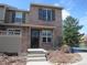 Charming two-story townhome featuring a brick facade, secure front door and well-manicured landscaping at 559 Alton Way # E, Denver, CO 80230