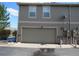 Attached two-car garage of a home with neutral siding and brick accents adding to the curb appeal at 559 Alton Way # E, Denver, CO 80230
