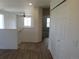 Bright hallway featuring hardwood floors, a staircase, and a white closet, offering a clean and inviting space at 559 Alton Way # E, Denver, CO 80230