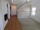 Open-concept living space featuring hardwood floors, neutral paint, fireplace, and a staircase to the upper level at 559 Alton Way # E, Denver, CO 80230