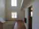 Inviting entryway with high ceilings, fireplace and a combination of hardwood and carpeted flooring at 559 Alton Way # E, Denver, CO 80230
