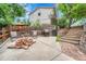 Private backyard patio with seating, a grill, and stone steps for relaxing and outdoor entertainment at 5964 S Florence Ct, Englewood, CO 80111