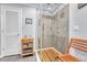 Sleek bathroom featuring a glass-enclosed shower with wood plank floor and wooden chair at 5964 S Florence Ct, Englewood, CO 80111