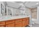 Large bathroom boasts dual vessel sinks, wood cabinets and a shower and tub area at 5964 S Florence Ct, Englewood, CO 80111