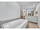 Bright bathroom featuring a soaking tub, shower, and modern fixtures at 5964 S Florence Ct, Englewood, CO 80111