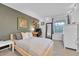 Stylish bedroom with a platform bed, desk, dresser, mirror and neutral tones at 5964 S Florence Ct, Englewood, CO 80111