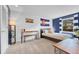 Bright bedroom featuring a bed, desk, bench, Colorado flag and blue accent wall at 5964 S Florence Ct, Englewood, CO 80111