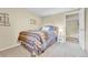 Neutral bedroom design featuring a colorful bedspread, nightstand, and accent wall decor at 5964 S Florence Ct, Englewood, CO 80111