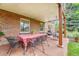 Charming covered patio featuring a dining table, chairs, and a cozy swing for outdoor enjoyment and gatherings at 5964 S Florence Ct, Englewood, CO 80111