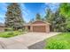 Charming brick home featuring a well-manicured lawn, beautiful landscaping, and a two-car garage at 5964 S Florence Ct, Englewood, CO 80111