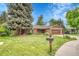 Charming brick home with lush front lawn, mature trees, tidy landscaping, and a two-car garage at 5964 S Florence Ct, Englewood, CO 80111