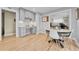 Modern kitchen area with built-in desk, dining table, and chairs, plus hardwood floors for a seamless transition at 5964 S Florence Ct, Englewood, CO 80111