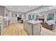 Open-concept kitchen features an island, stainless steel appliances, and seamless flow into a sunny living area at 5964 S Florence Ct, Englewood, CO 80111