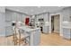 Spacious kitchen boasts a large island with bar seating, stainless steel appliances, and ample cabinet space at 5964 S Florence Ct, Englewood, CO 80111
