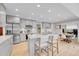 Well-lit kitchen with an island, stainless appliances, modern finishes, and adjacent dining and office areas at 5964 S Florence Ct, Englewood, CO 80111