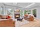 Sunlit living room featuring a fireplace, ample seating, hardwood floors, and large windows offering serene views at 5964 S Florence Ct, Englewood, CO 80111