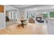 Open-concept living space features a dining table, hardwood floors, and seamless transition to a cozy living room at 5964 S Florence Ct, Englewood, CO 80111