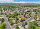 Scenic aerial view of property nestled amidst vibrant greenery and city skyline at 2311 Emery Pl, Longmont, CO 80501