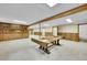 Spacious basement with carpet, shelving and wood beam that could be used for recreation or storage at 2311 Emery Pl, Longmont, CO 80501