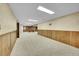 Finished basement featuring wood paneling, carpet and exposed brick area for game playing at 2311 Emery Pl, Longmont, CO 80501