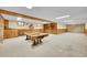 Spacious carpeted basement with wood paneled walls and shelving at 2311 Emery Pl, Longmont, CO 80501