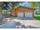 Two car garage with a brick facade and white doors provides convenient parking and storage space at 2311 Emery Pl, Longmont, CO 80501