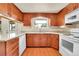 Traditional kitchen featuring wood cabinets, granite countertops and updated white appliances at 2311 Emery Pl, Longmont, CO 80501