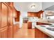 Functional kitchen featuring wood cabinets, laminate countertops, and hardwood floors at 2311 Emery Pl, Longmont, CO 80501