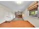 Bright living room with a brick fireplace, ceiling fan and hardwood floors at 2311 Emery Pl, Longmont, CO 80501
