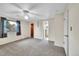 Main bedroom featuring carpet, a ceiling fan, a window and ensuite bathroom access at 2311 Emery Pl, Longmont, CO 80501