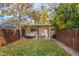 Backyard featuring a well-maintained lawn, string lights, an outdoor seating area and privacy fence at 3929 Shoshone St, Denver, CO 80211