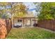 Backyard featuring a well-maintained lawn, string lights, an outdoor seating area and privacy fence at 3929 Shoshone St, Denver, CO 80211